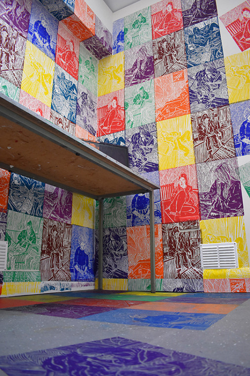 Lino cut prints in various colours on classroom walls and floor